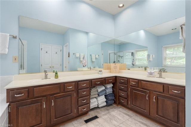 6516 Dornoch Dr, Greensboro, NC 27410 - full bathroom with a shower stall, double vanity, and tile patterned flooring