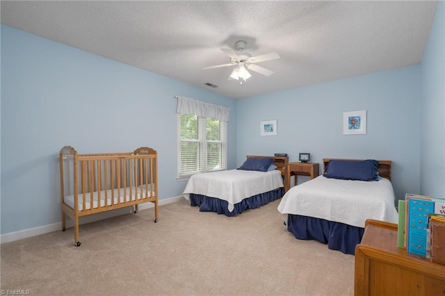 6516 Dornoch Dr, Greensboro, NC 27410 - carpeted bedroom with a textured ceiling, baseboards, and a ceiling fan