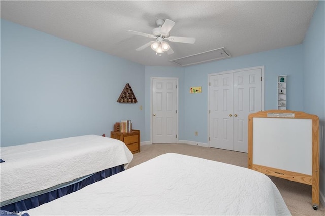 6516 Dornoch Dr, Greensboro, NC 27410 - bedroom with light colored carpet, attic access, a closet, a ceiling fan, and a textured ceiling