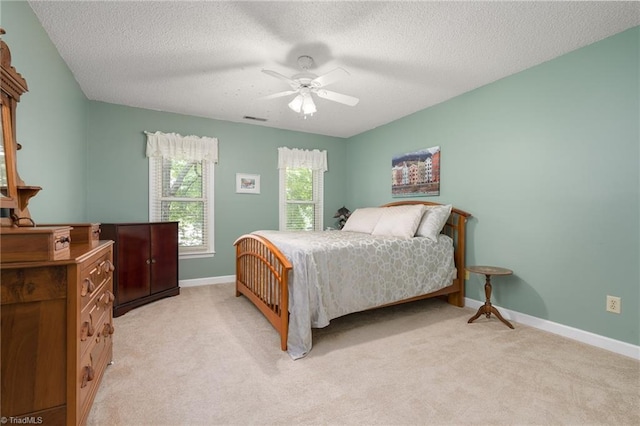 6516 Dornoch Dr, Greensboro, NC 27410 - bedroom with light carpet, a textured ceiling, baseboards, and a ceiling fan