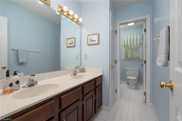 6516 Dornoch Dr, Greensboro, NC 27410 - bathroom featuring tile patterned flooring, toilet, double vanity, and baseboards