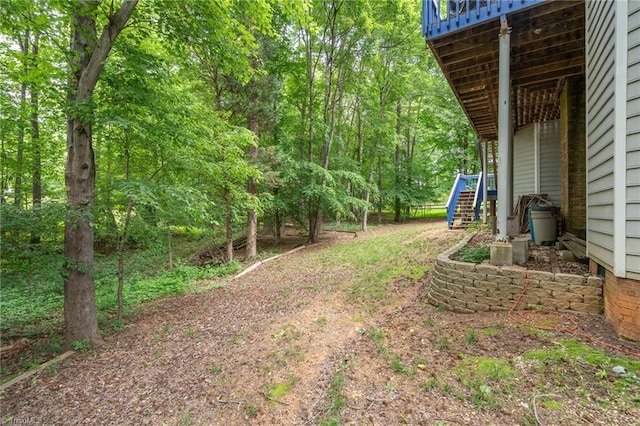 6516 Dornoch Dr, Greensboro, NC 27410 - view of yard featuring stairs and a wooden deck