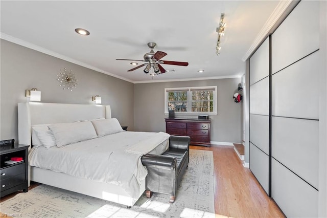 bedroom featuring crown molding, ceiling fan, and light hardwood / wood-style flooring