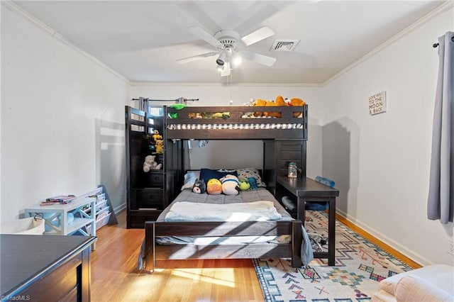 bedroom featuring crown molding and hardwood / wood-style flooring