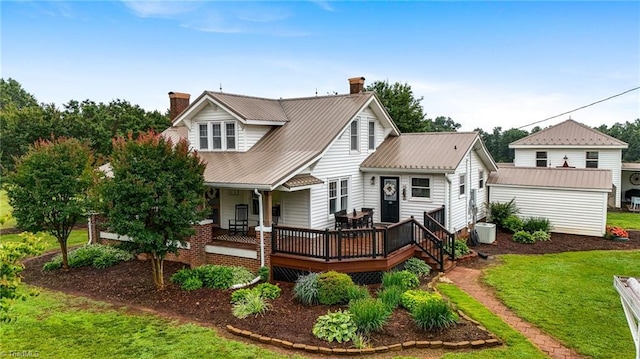 3412 Smithtown Rd, East Bend, NC 27018 - rear view of house with a chimney, a lawn, and metal roof