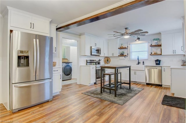 3412 Smithtown Rd, East Bend, NC 27018 - kitchen with stainless steel appliances, open shelves, washer / clothes dryer, a sink, and crown molding