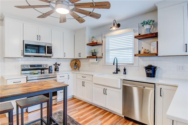 3412 Smithtown Rd, East Bend, NC 27018 - kitchen with stainless steel appliances, open shelves, a sink, ceiling fan, and light countertops