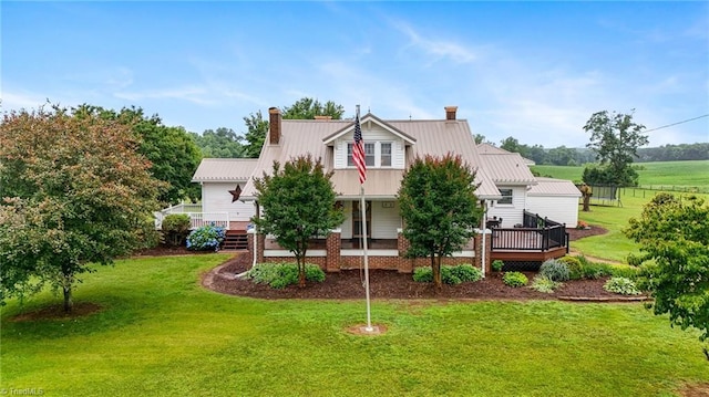 3412 Smithtown Rd, East Bend, NC 27018 - view of front facade with a front lawn, a chimney, a wooden deck, and metal roof