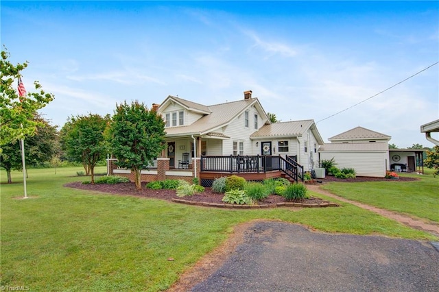 3412 Smithtown Rd, East Bend, NC 27018 - view of front of house featuring a front lawn, a chimney, and a wooden deck