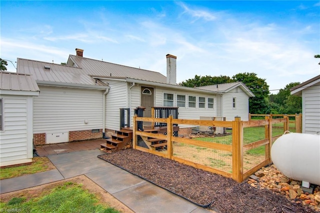 3412 Smithtown Rd, East Bend, NC 27018 - back of house featuring a chimney, metal roof, and crawl space