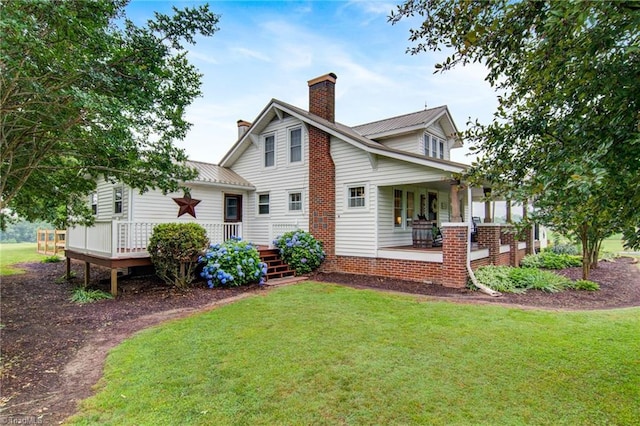 3412 Smithtown Rd, East Bend, NC 27018 - rear view of property with a chimney, a yard, covered porch, and metal roof