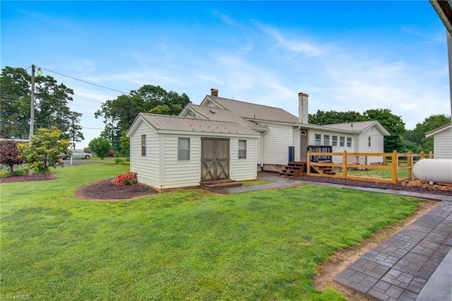 3412 Smithtown Rd, East Bend, NC 27018 - rear view of property with a chimney, an outbuilding, metal roof, and a deck