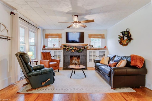 3412 Smithtown Rd, East Bend, NC 27018 - living room with ceiling fan, ornamental molding, wood finished floors, and a fireplace