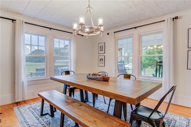 3412 Smithtown Rd, East Bend, NC 27018 - dining area featuring crown molding, a chandelier, plenty of natural light, and light wood-style flooring