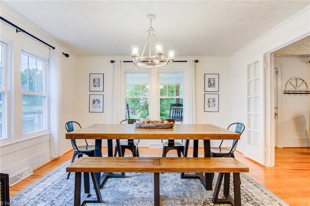 3412 Smithtown Rd, East Bend, NC 27018 - dining area with a chandelier, plenty of natural light, light wood finished floors, and crown molding