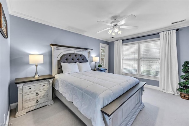 bedroom with ornamental molding, light colored carpet, visible vents, and a ceiling fan