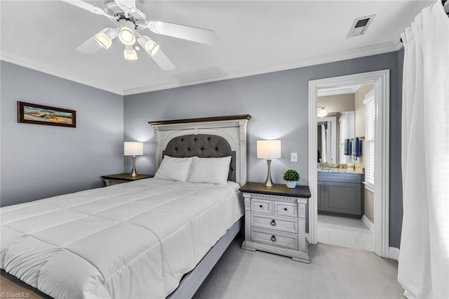 bedroom featuring light colored carpet, a ceiling fan, visible vents, ornamental molding, and ensuite bath