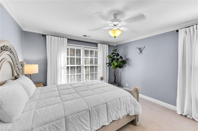 bedroom with carpet flooring, a ceiling fan, baseboards, visible vents, and crown molding