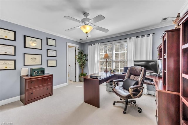 carpeted office with crown molding, baseboards, and ceiling fan