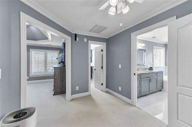 bedroom featuring a sink, multiple windows, baseboards, and crown molding