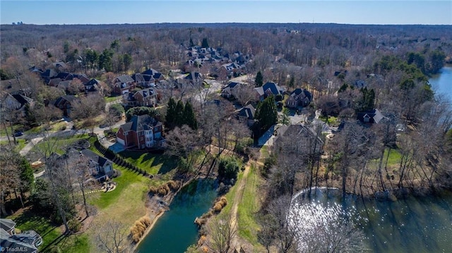 aerial view featuring a water view and a forest view