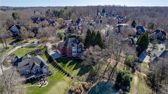 drone / aerial view featuring a forest view and a residential view