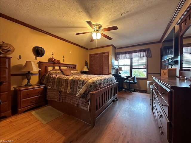 bedroom with hardwood / wood-style floors, crown molding, and a textured ceiling