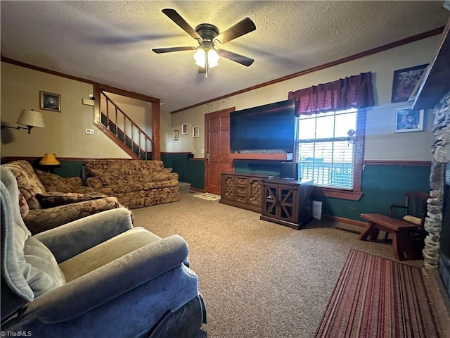 carpeted living room featuring crown molding, ceiling fan, and a textured ceiling