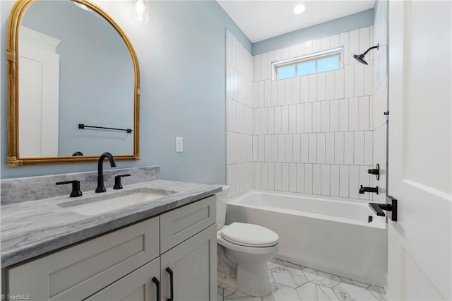 full bathroom with vanity, tiled shower / bath combo, and toilet