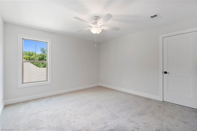 unfurnished room featuring light colored carpet and ceiling fan