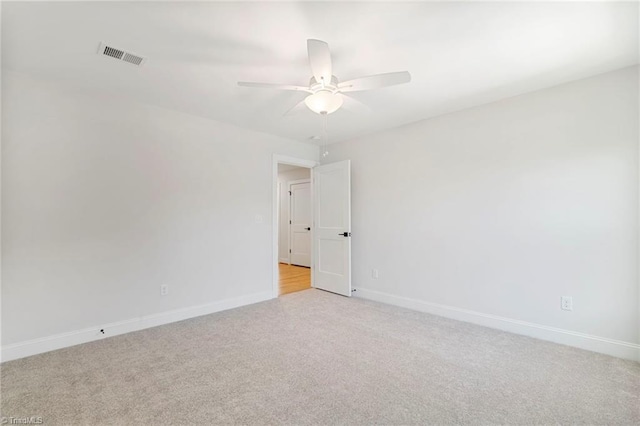 carpeted spare room with ceiling fan