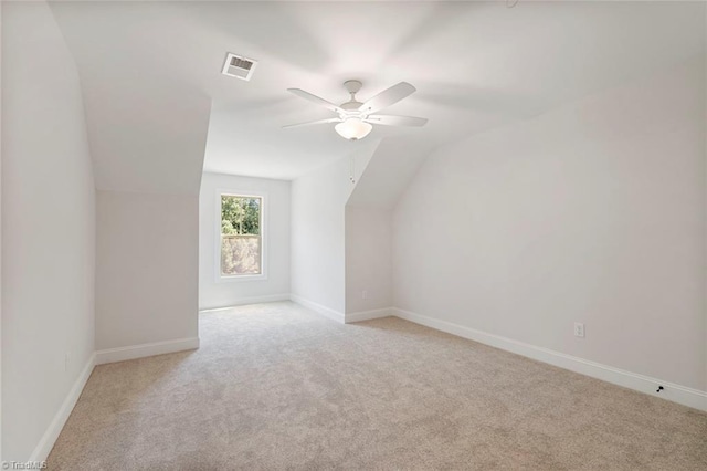 bonus room featuring vaulted ceiling, light carpet, and ceiling fan