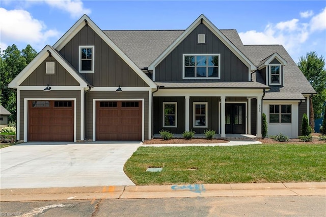 craftsman-style home with a garage, a porch, and a front lawn