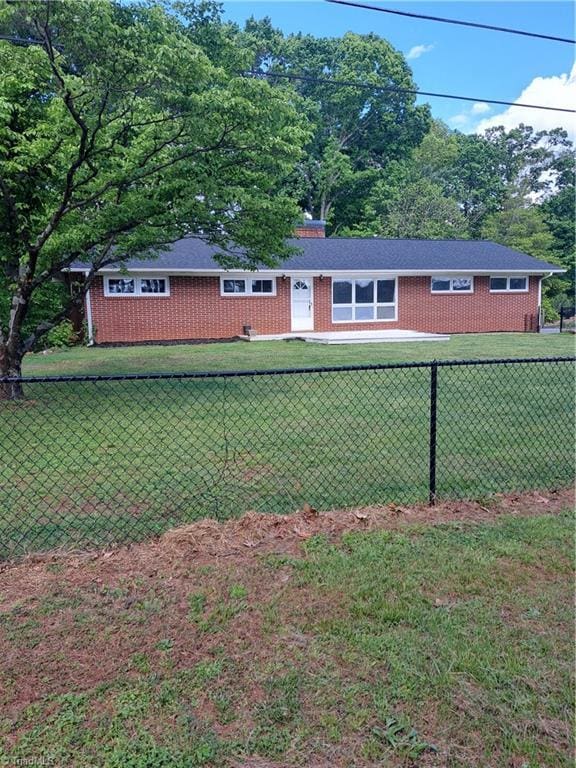 view of front of home featuring fence private yard and a front lawn