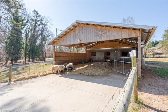 exterior space with a carport, an exterior structure, driveway, and an outbuilding