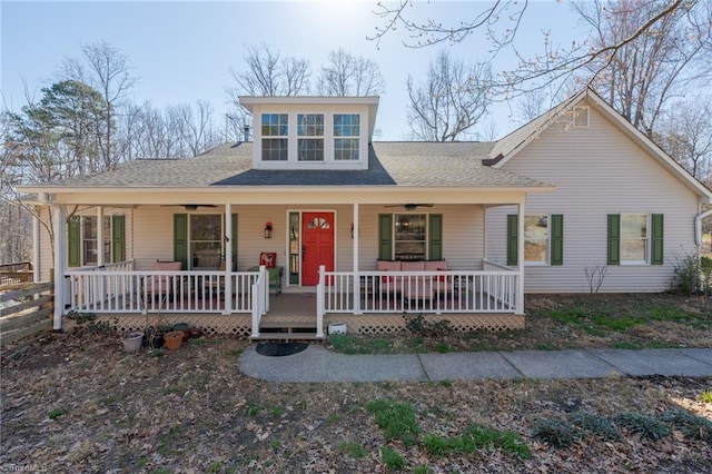 view of front of house featuring roof with shingles, covered porch, and a ceiling fan