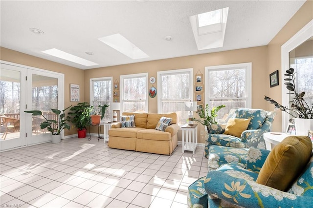 living room featuring light tile patterned floors, plenty of natural light, a textured ceiling, and a skylight