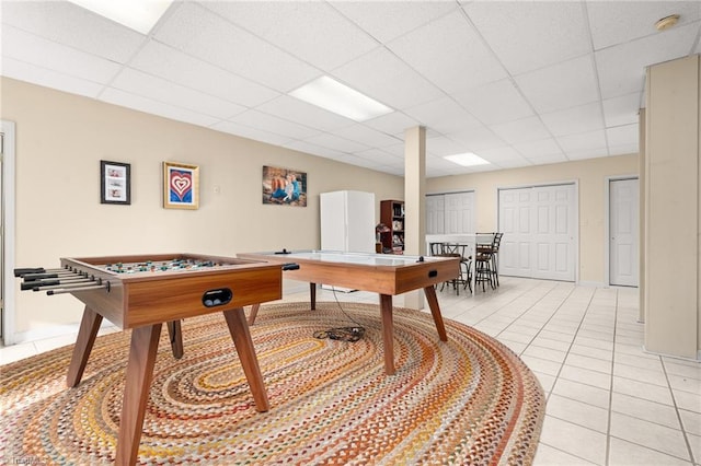 game room featuring light tile patterned floors and a drop ceiling