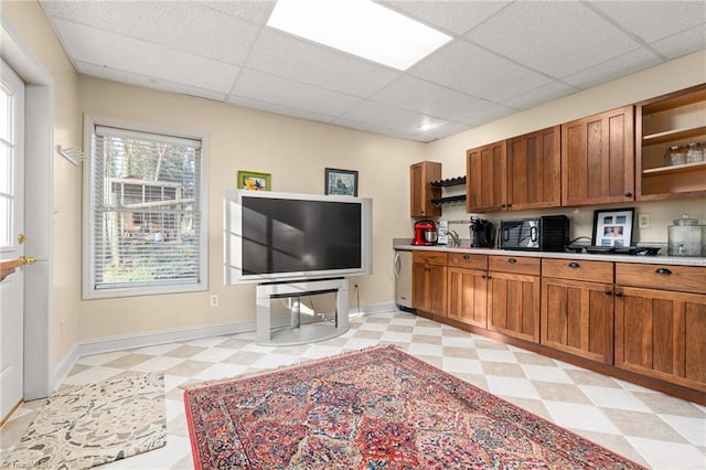 kitchen featuring open shelves, light floors, brown cabinetry, and light countertops