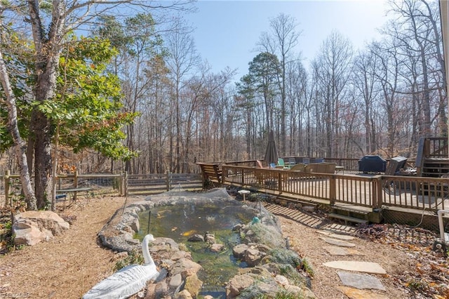 view of yard with a deck and fence