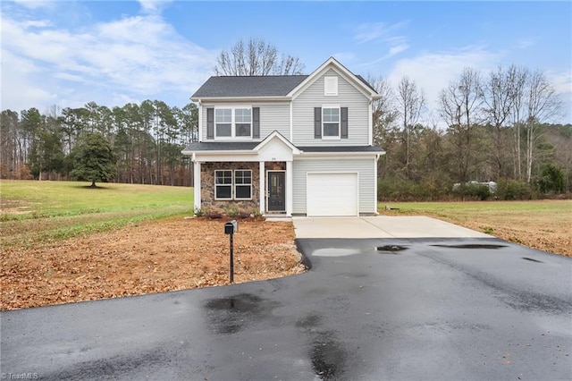 front of property with a garage and a front lawn