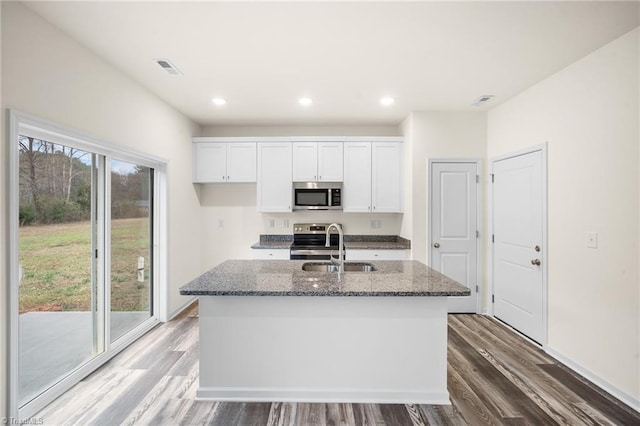 kitchen with white cabinetry, an island with sink, and appliances with stainless steel finishes