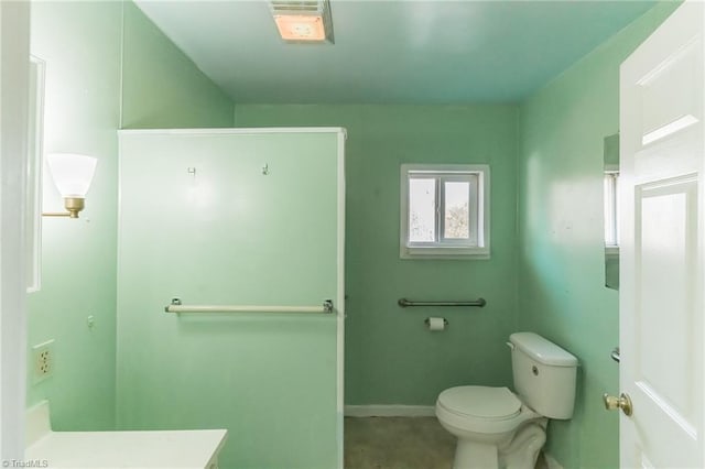 bathroom with vanity, toilet, and baseboards