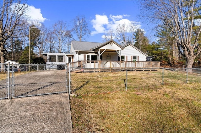 view of front of property with aphalt driveway, a front yard, a gate, metal roof, and fence private yard