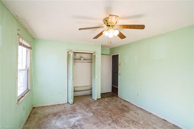 unfurnished bedroom with ceiling fan and a closet