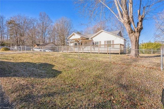 back of property with a fenced backyard and a lawn