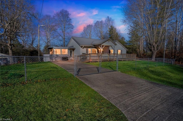 view of front of property with a fenced front yard, a gate, and a front lawn