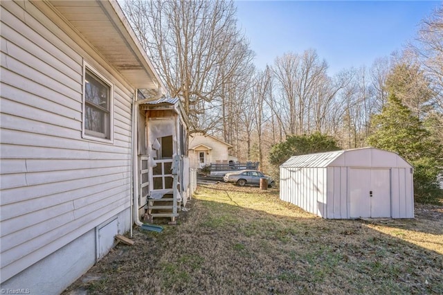 view of yard featuring entry steps, a storage unit, and an outdoor structure