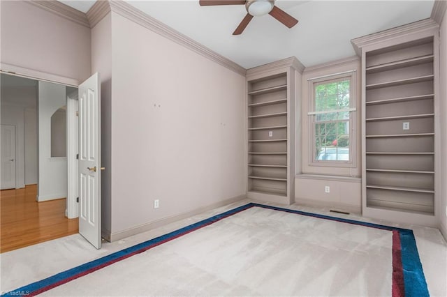 unfurnished bedroom featuring a ceiling fan, baseboards, carpet floors, and ornamental molding