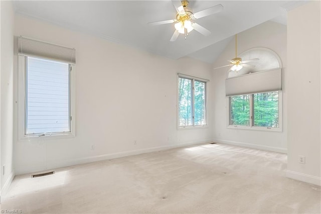 spare room with vaulted ceiling, ceiling fan, baseboards, carpet flooring, and visible vents